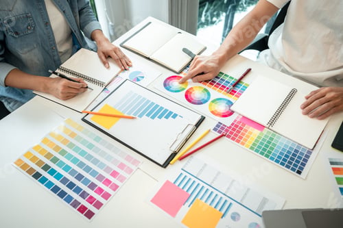 Preview: Two creative graphic designer team working on color selection and drawing on graphic tablet