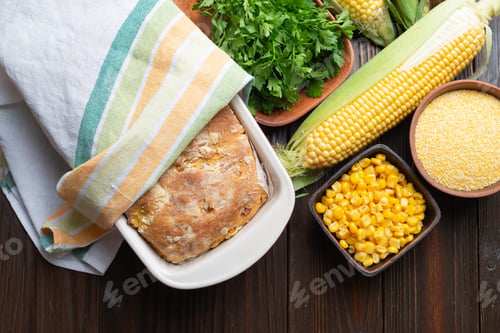 Preview: Cornbread in ceramic baking dish on wooden kitchen table flat lay view