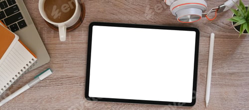 Preview: A white blank screen computer tablet is putting on a table surrounded by various equipment.