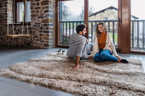 Preview: A caucasian couple relaxing in the attic of their home with a beautiful window and natural light.