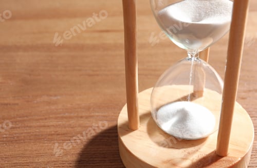 Preview: Hourglass with flowing sand on wooden background. Time management
