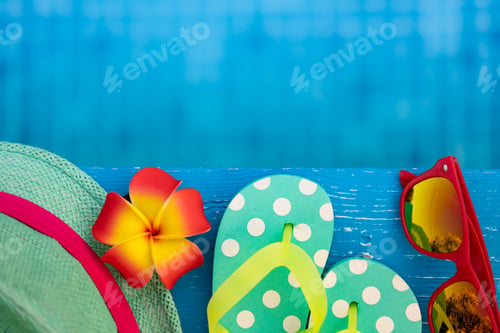 Preview: Beach flip-flops on blue wooden background