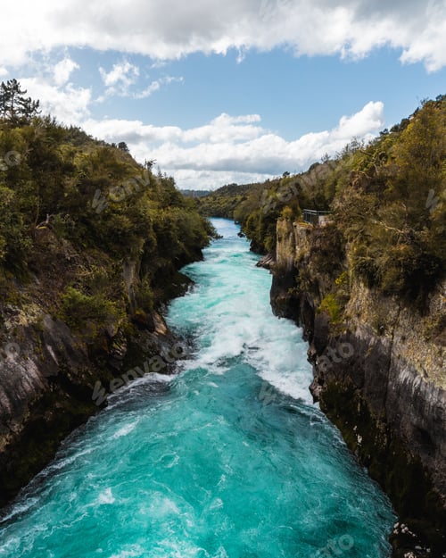 Preview: Aerial view of foamy Huka Falls waterfall flowing through cliffs on Waikato River in New Zealand