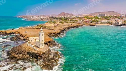 Preview: Aerial view of the shore of Praia de Santiago and the Praia lighthouse on a sunny day