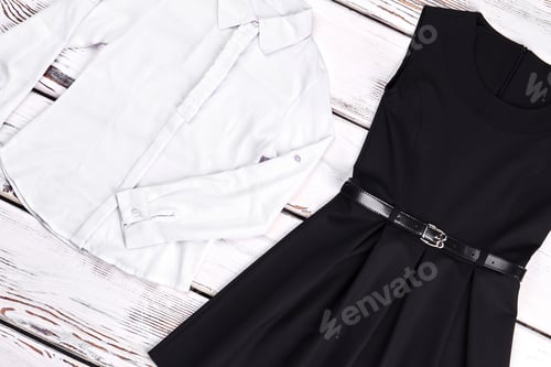 Preview: White Shirt and Black Dress on Wooden Surface