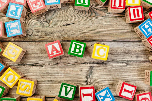 Preview: Letters background. Wooden cubes with letters on wooden background