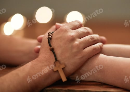 Preview: Hands are there to help others. Cropped shot of two people holding hands and praying together.