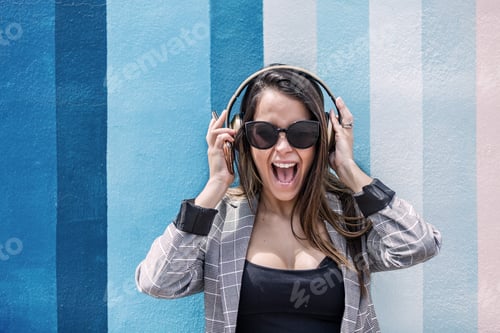 Preview: Excited woman listening to music and screaming