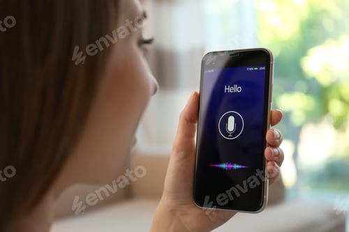 Preview: Woman using voice search on smartphone indoors, closeup