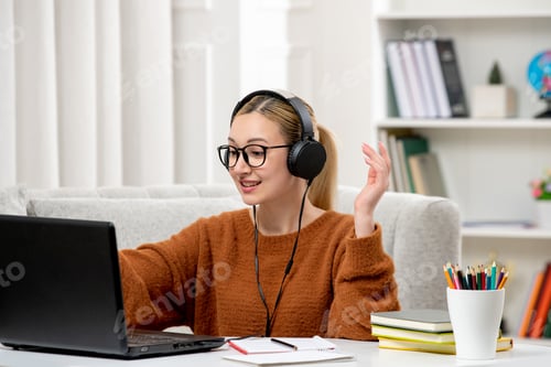 Preview: student online young cute girl in glasses and orange sweater studying on computer typing