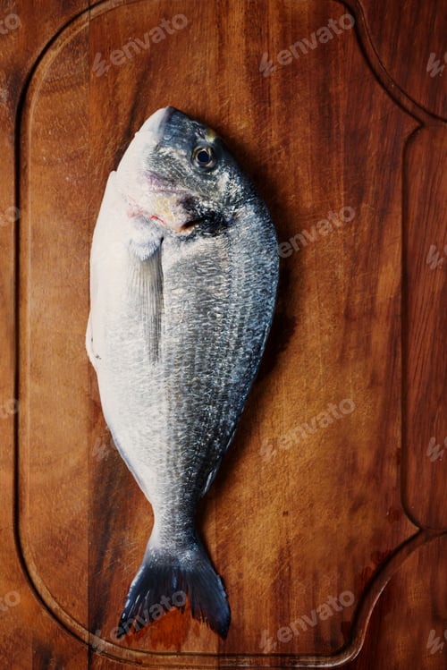 Preview: Healthy fresh raw fish on the wooden board