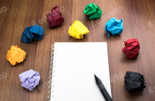 Preview: open blank white book with group of colorful crumpled paper ball