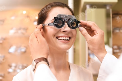 Preview: Woman having eye examination with phoropter in optical store. Ophthalmologist prescription