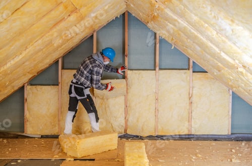 Preview: Worker Installs Mineral Wool Insulation in Residential Attic During Daylight Hours