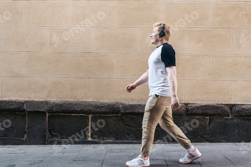 Preview: albino young man walking down the street in white clothes