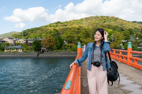 Preview: woman looking at natural scenery over uji river