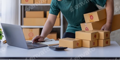 Preview: Close up of Hand man small business SME entrepreneur working at home, online marketing, packing box