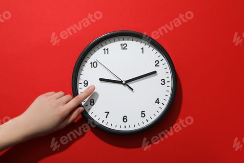 Preview: Concept of time change with clock on red background