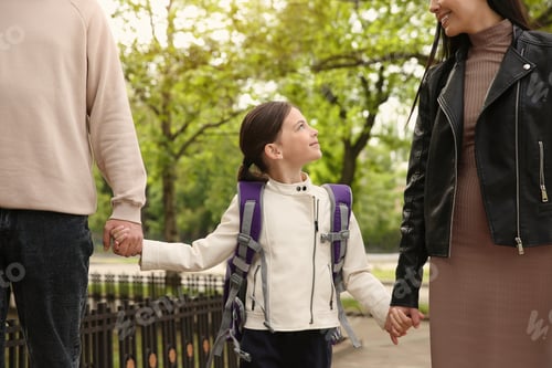 Preview: Parents taking their little daughter to school outdoors