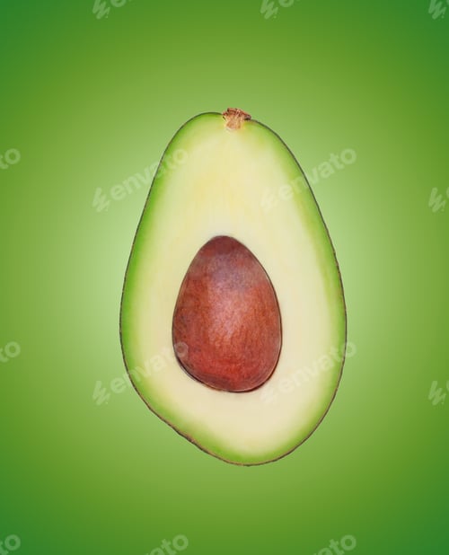 Preview: avocado cut in half on a light green background