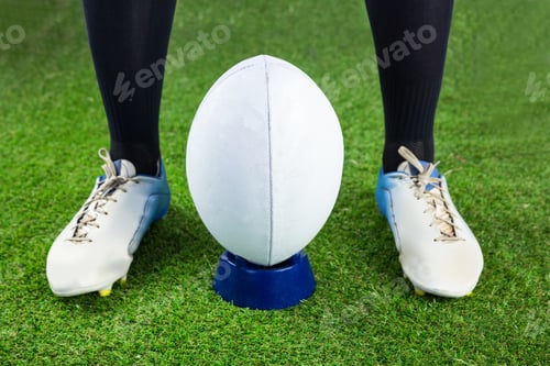 Preview: Low angle view of a rugby player ready to make a drop kick