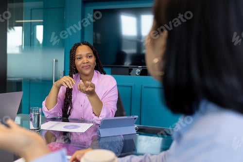 Preview: Two young biracial female colleagues discuss teamwork, business, and startup ideas