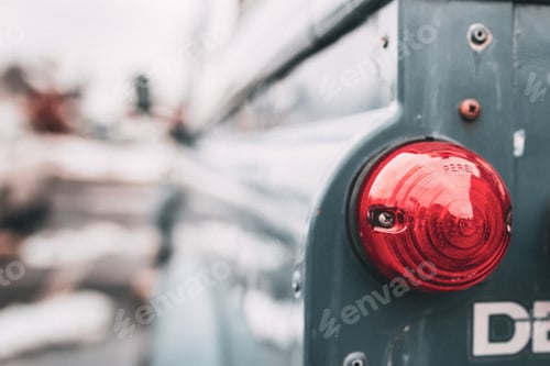 Preview: Closeup shot of a red taillight at the rear of a car