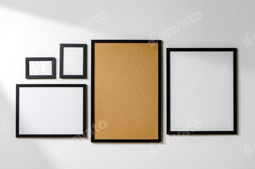 Preview: Set of black frames on white wall with copy space