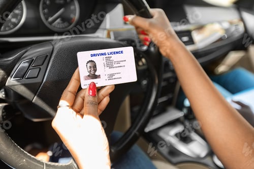 Preview: Newest driving license in black lady hands, closeup