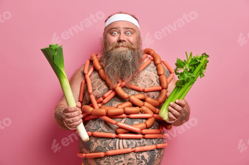 Preview: Obesity and healthy diet concept. Funny overweight bearded man holds green vegetables, has healthy n