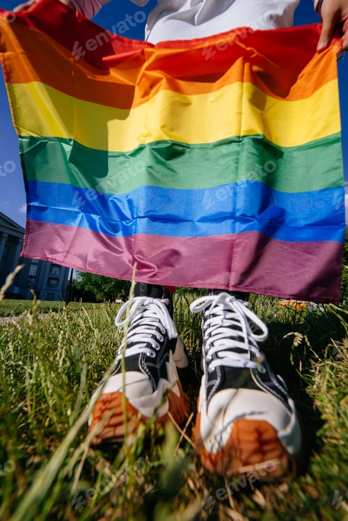 Preview: Cropped photo of young woman with LGBT pride flag.