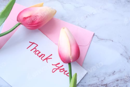 Preview: thank you message on sticky note with tulip flower on tiles background