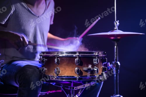 Preview: A drummer plays drums on a blue background. Beautiful special effects of light and smoke.