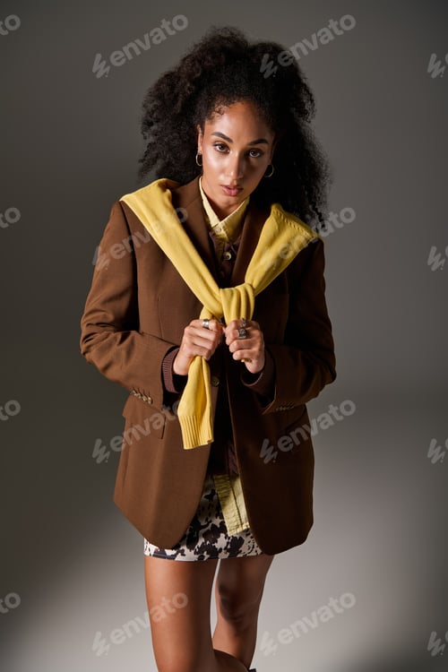 Preview: Fashionable autumn look showcased by a stylish woman in a studio setting