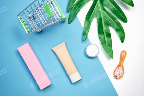 Preview: Mockup of cosmetic cream bottle, Blank label package and ingredients on a green leaves background