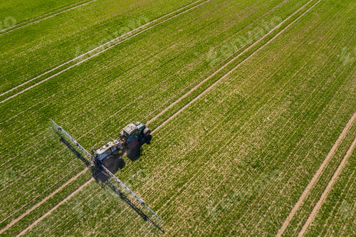 Preview: tractor spraying herbicides on field, Tractor Spraying Chemicals on Field - GMO Crops