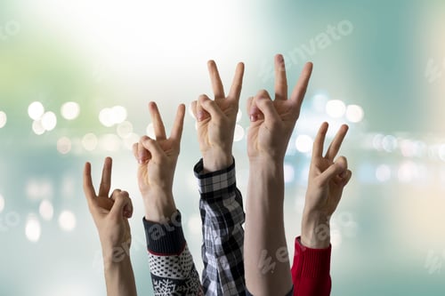 Preview: a large group of people rise hands and show peace sign, no war concept