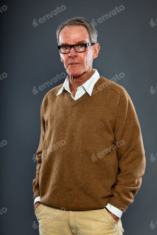 Preview: Expressive Good Looking Senior Man Wearing Glasses Against Grey Wall. Funny And Characteristic