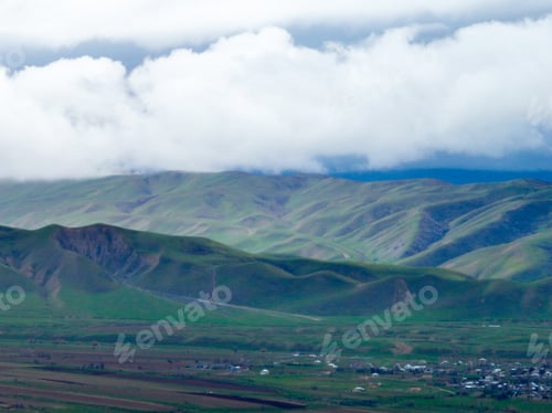 Preview: Green Rolling Foothills Under Heavy Cloud Layer