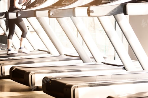 Preview: Woman running in a gym on a treadmill concept for exercising, fitness and healthy lifestyle