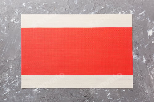 Preview: Top view of red tablecloth for food on cement background. Empty space for your design