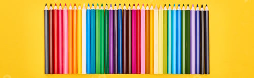 Preview: Panoramic shot of straight line of color pencils isolated on yellow