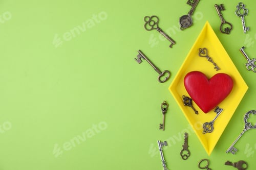 Preview: Flat lay composition with different keys and decorative heart on color background. Space for text