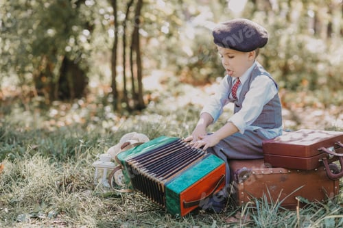 Preview: Little boy in a cap with an accordion