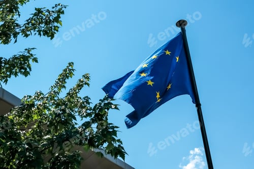 Preview: European union flag waving against blue sky.