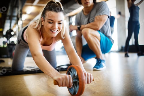 Preview: Fit sportswoman exercising and training at fitness club