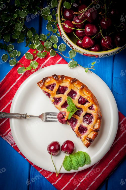 Preview: Homemade cherry pie on blue table.