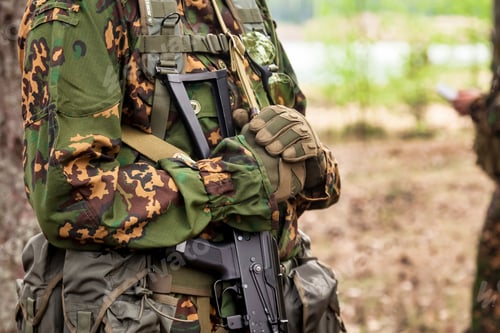 Preview: Close up hands russian soldier man dressed military camouflage uniform with machine gun in woodland