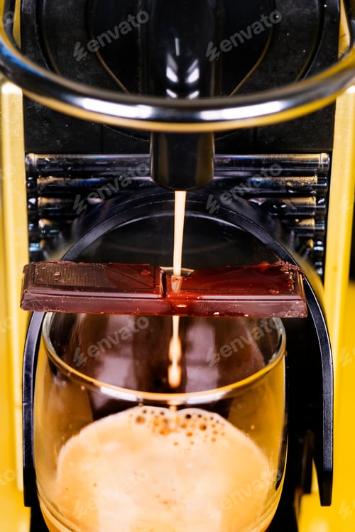 Preview: Machine coffee making with a portion of chocolate falling apart at the top of the glass.
