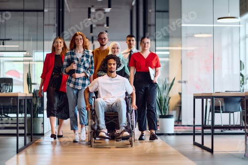 Preview: A diverse group of young business people walking a corridor in the glass-enclosed office of a modern